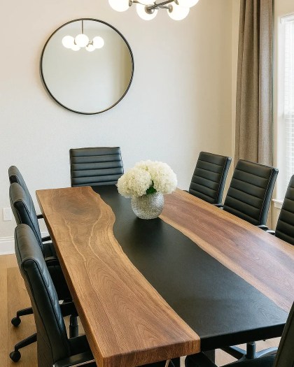 Black Walnut live edge conference table with Sumi Black resin river, surrounded by modern black leather chairs in a bright office setting