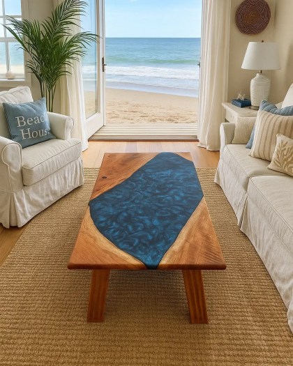 Cherry wood resin river coffee table with ocean-blue Macaw resin, displayed in a coastal beach house living room overlooking the sea